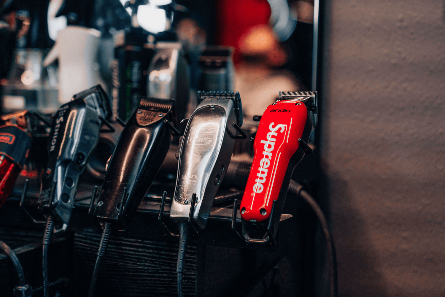 Five clippers lined up against a mirror.