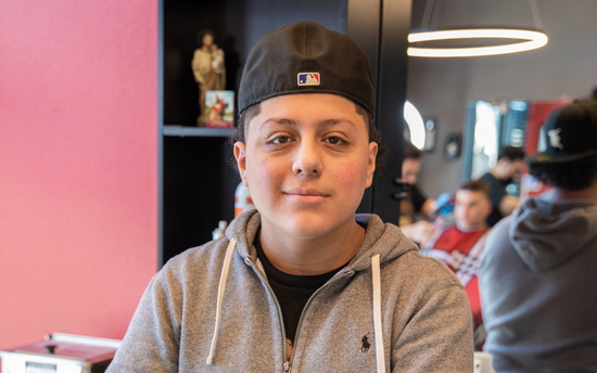 Barber with a black hat and grey sweater