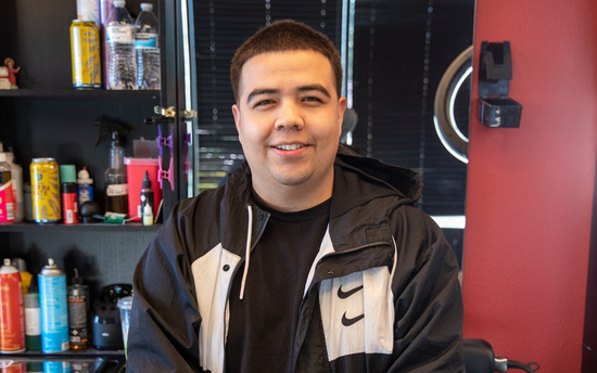Barber with a black and white sweater